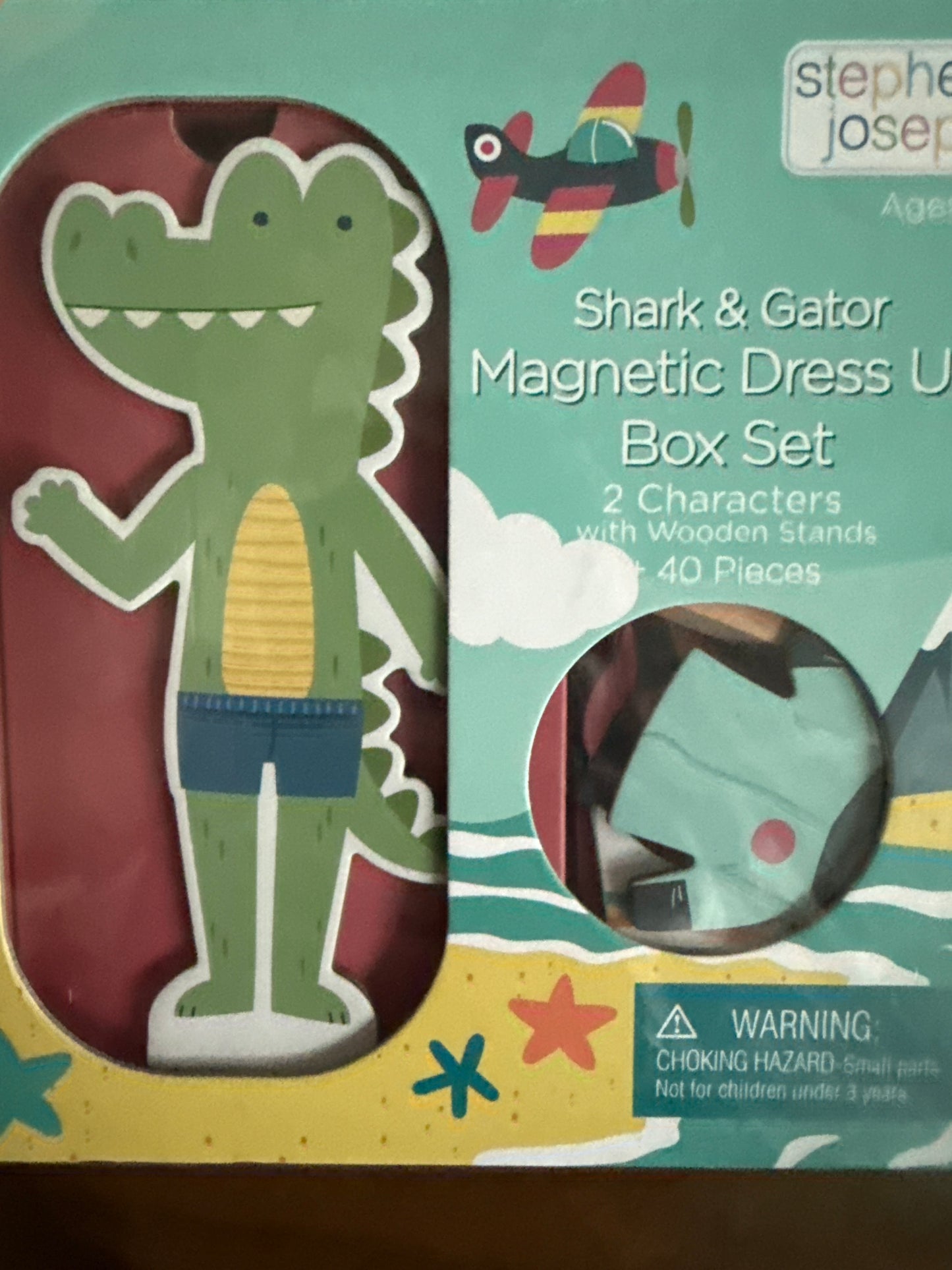 Magnetic dress-up set with flip-top cardboard case, three magnetic sheets, shark and gator character themes