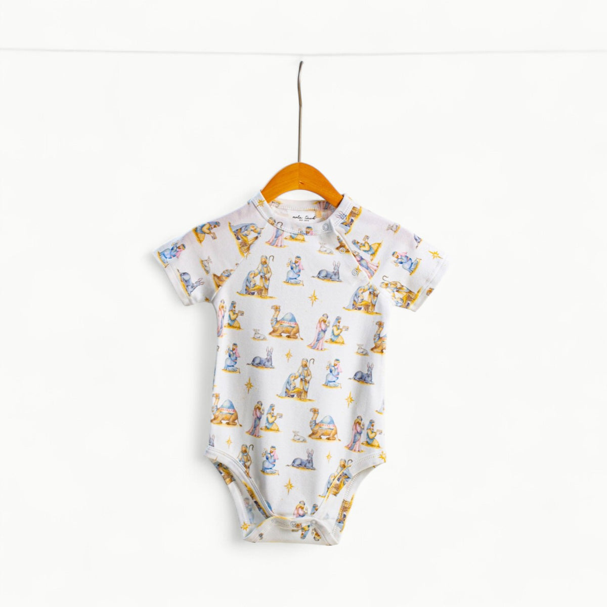 O Holy Night organic cotton onesie by Nola Tawk in natural cream, with shoulder and bottom snap closures