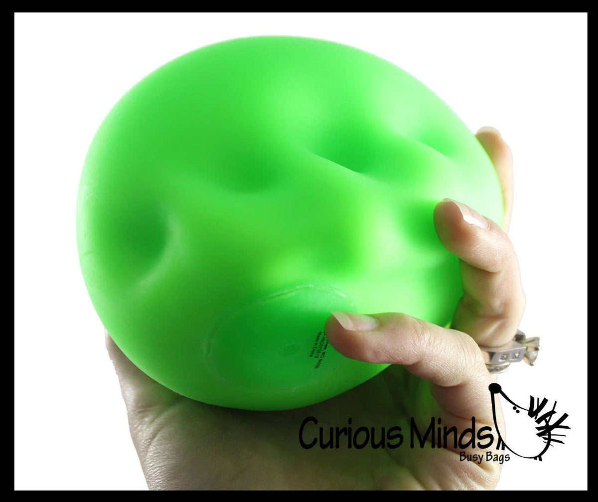 Jumbo 4-inch Nee Doh stress stretch ball in neutral tone, soft and moldable fidget toy