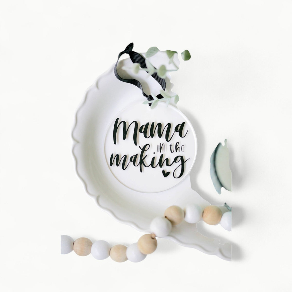 Clear acrylic Mama In The Making ornament with vinyl detail, 4 inch diameter, black ribbon hanger