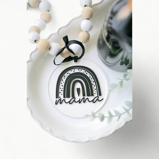 Rainbow Mama acrylic ornament by Younique, 4 inches, hanging from black ribbon