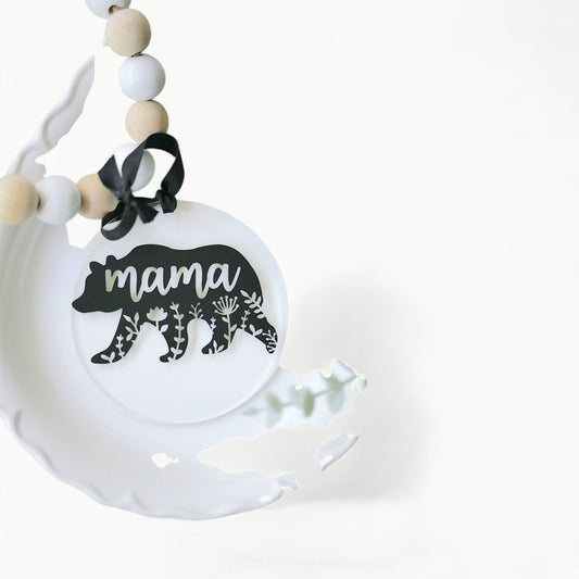 Clear acrylic ornament with detailed mama bear mandala design, suspended by black ribbon