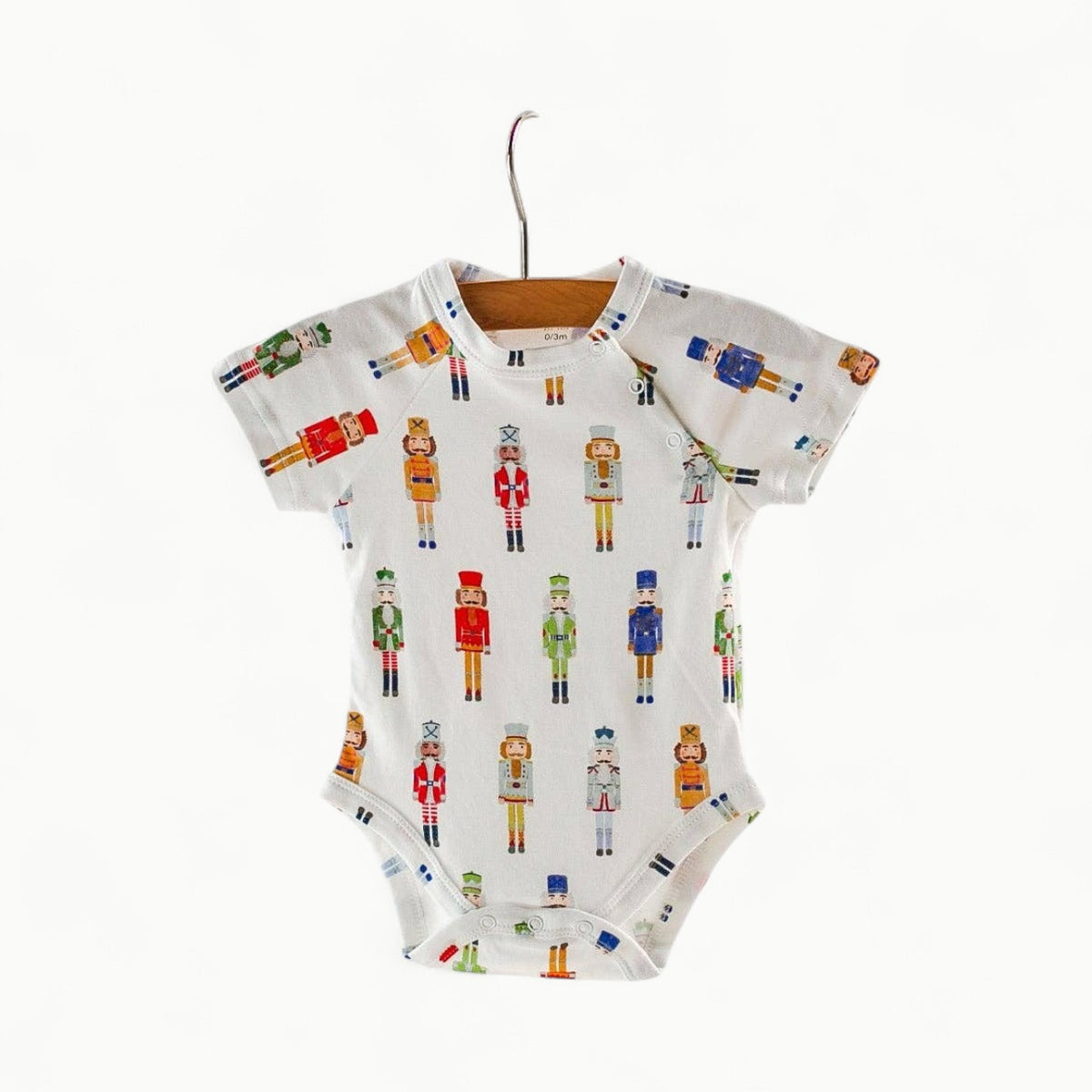 Nutty or Nice organic cotton onesie in natural cream, featuring shoulder snaps and snug fit