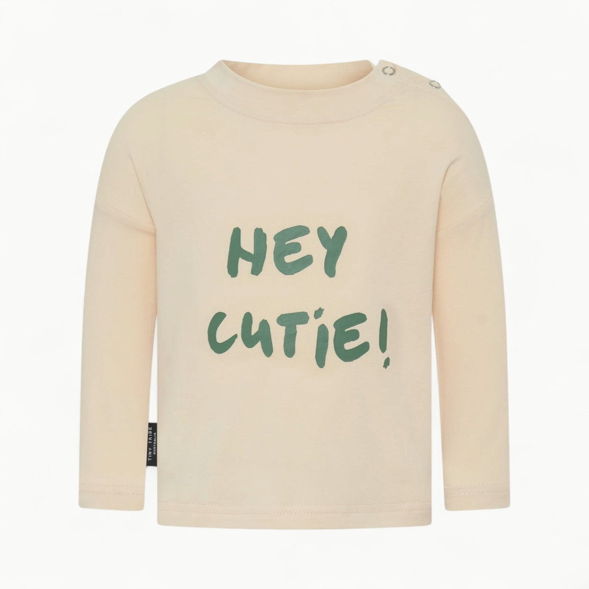 Hey Cutie Tee by Tiny Tribe in cream, featuring centre-front typography and side snap button detailing.