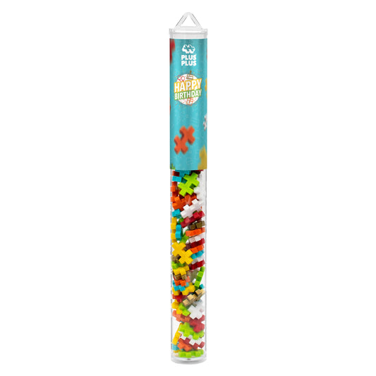 Plus-Plus Happy Birthday tube with 70 interlocking pieces in seven colors arranged on white background