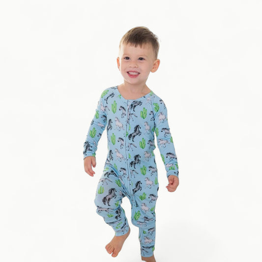 Harrison Poppy Convertible Romper in sky-blue with hand-illustrated horse and cactus print, convertible feet design