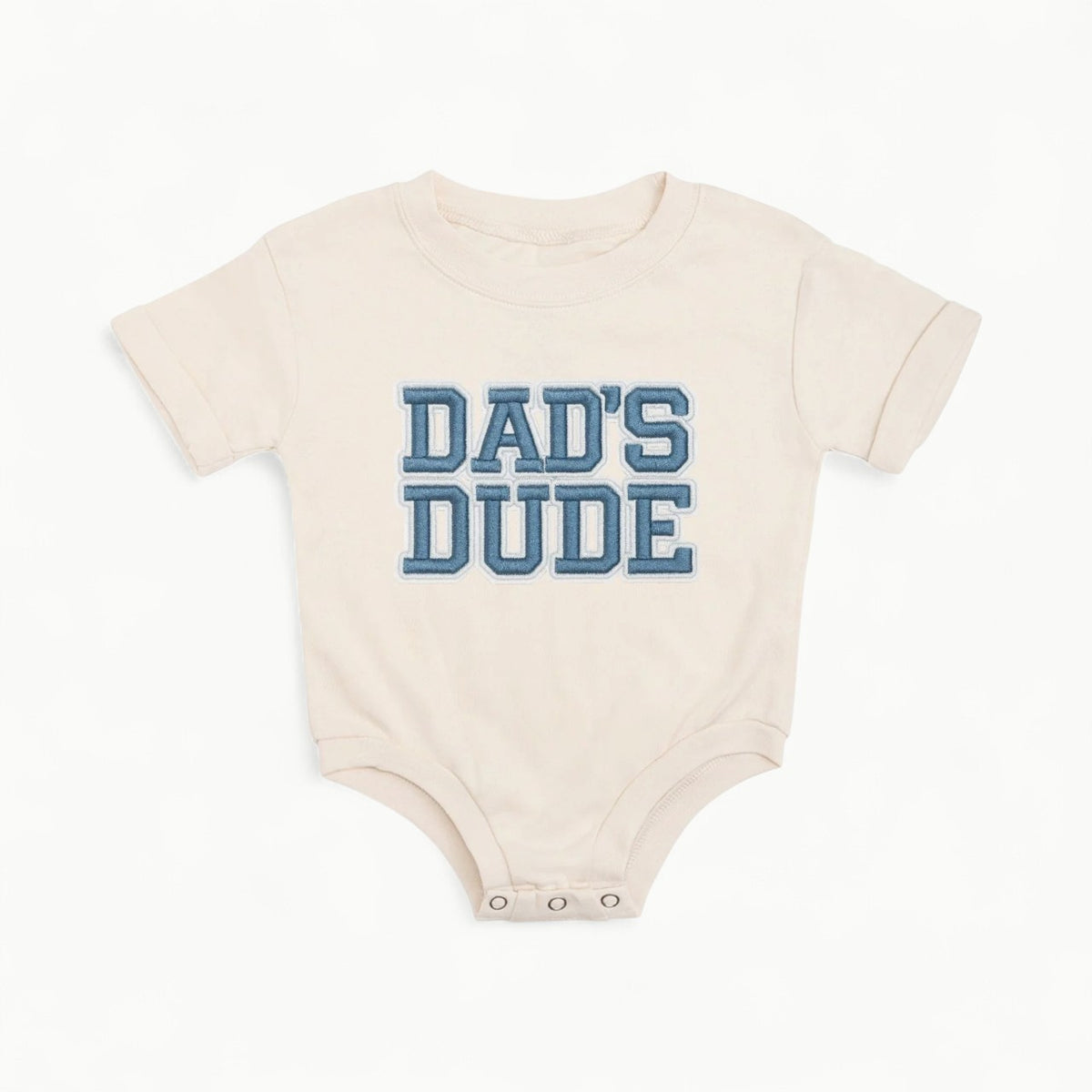 Natural cotton romper with navy embroidered dad patch and three-snap bubble design