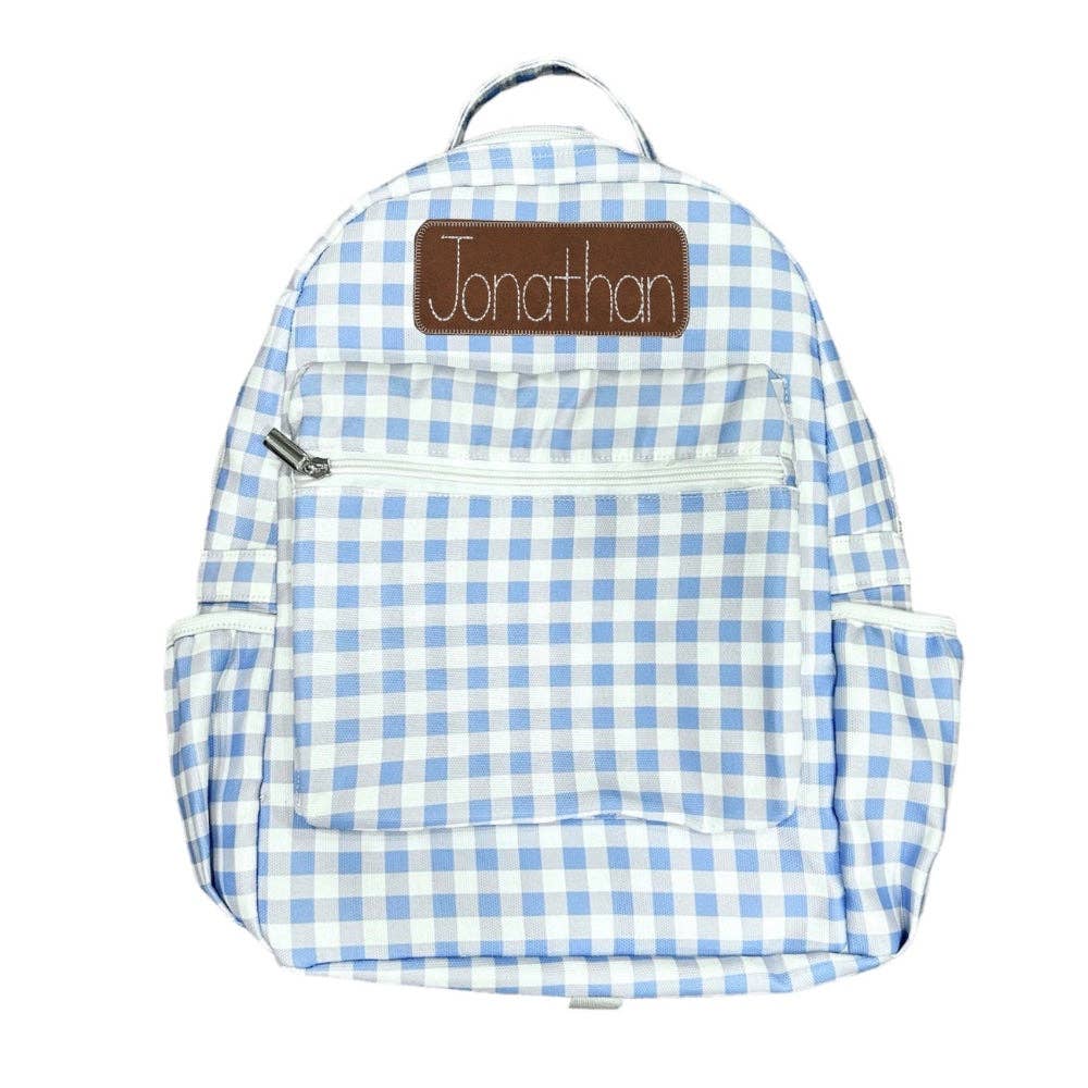 Blue gingham backpack by Sugar Bee Clothing with front pocket and side storage details