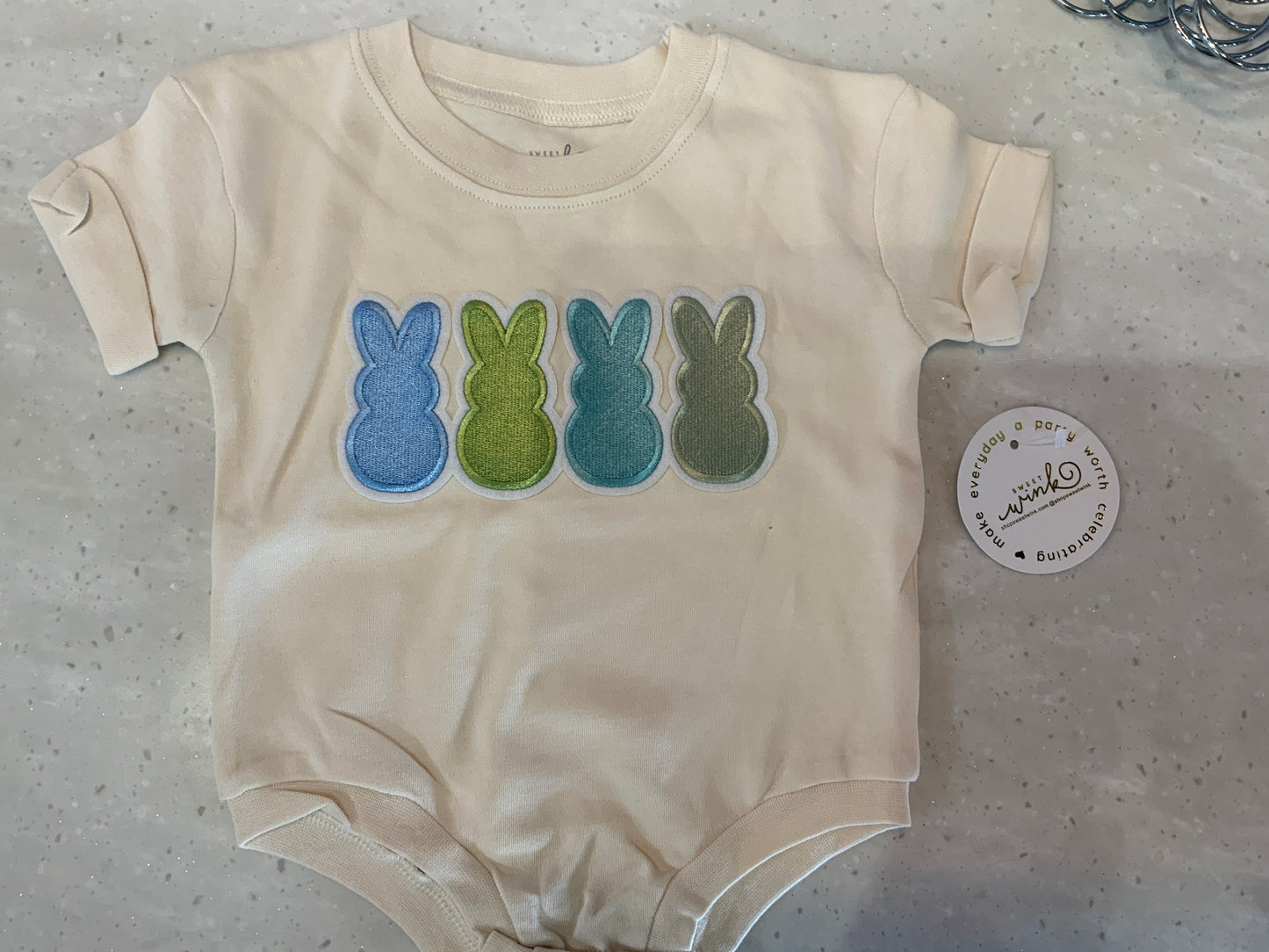 Natural short-sleeve romper with embroidered Peeps patch by Sweet Wink