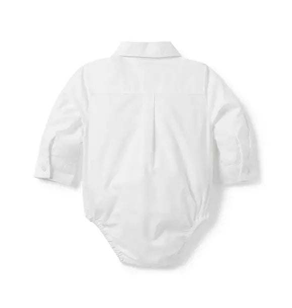 White long-sleeve collared bodysuit with embroidered train, chest pocket, and button-front closure
