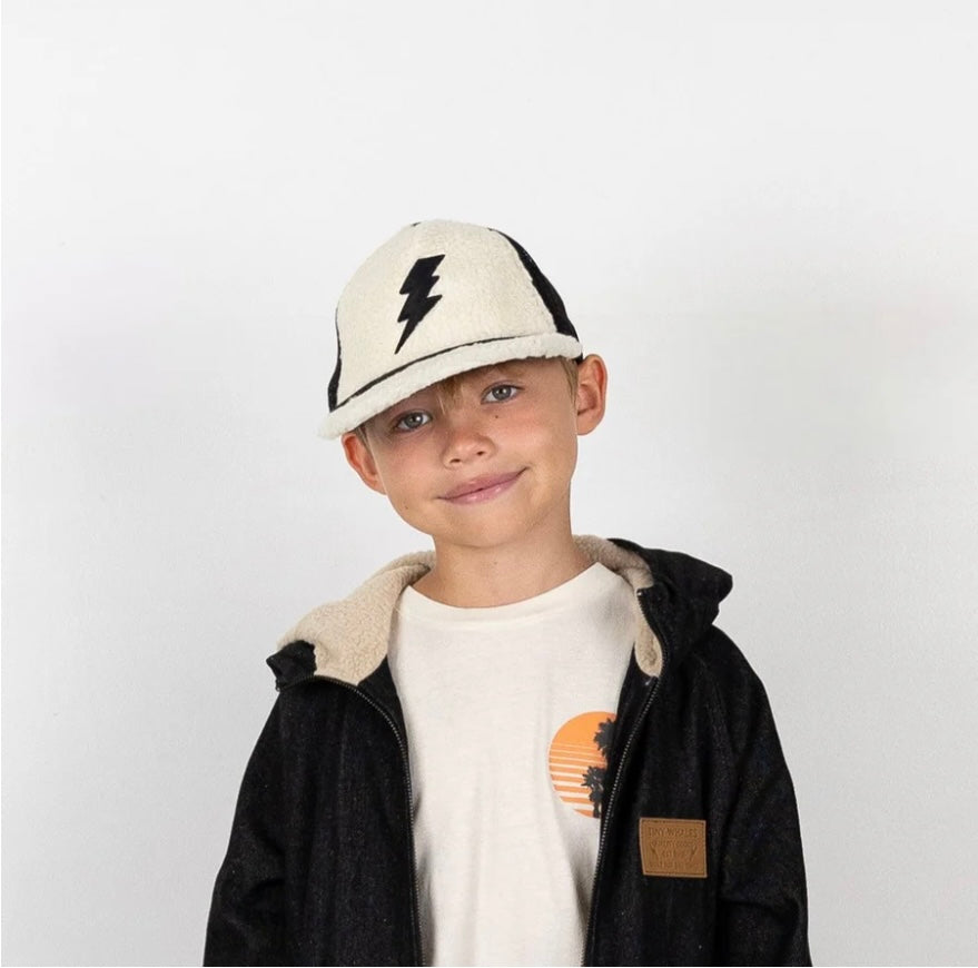 Natural sherpa trucker hat with nylon mesh panels and embroidered bolt detail, adjustable snap back closure