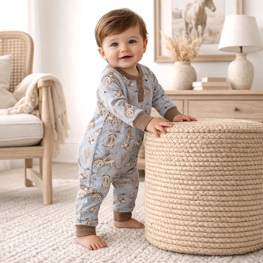 Wild Wrangler blue Henley long-sleeve romper with cowboy print and wooden buttons by Tesa Babe
