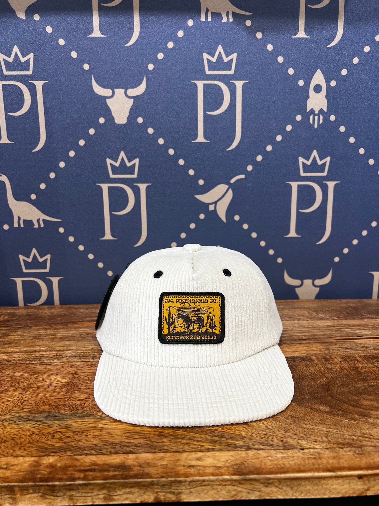 Cream corduroy trucker hat with embroidered T.W. Provisions Co. patch and mesh back panels