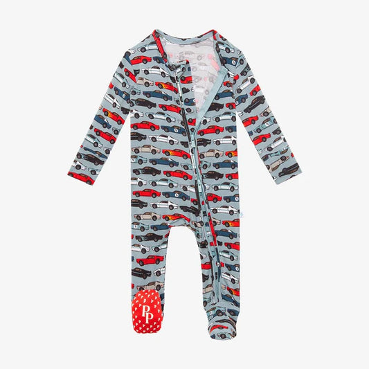 Posh Peanut Miles footed pajamas in blue, red, and black with race car design and 2-way zippers