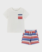 Load image into Gallery viewer, A white crew neck t-shirt with a red white and blue striped pocket detail. The shirt is paired with a red white and blue striped pair of shorts with a drawstring closure. 
