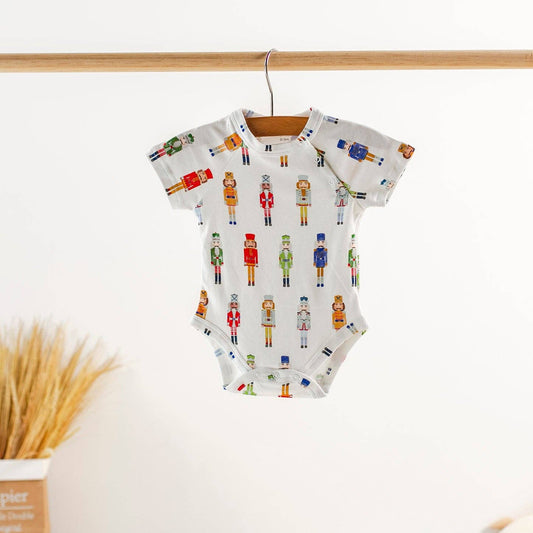 Nutty or Nice organic cotton onesie in natural cream, featuring shoulder snaps and snug fit
