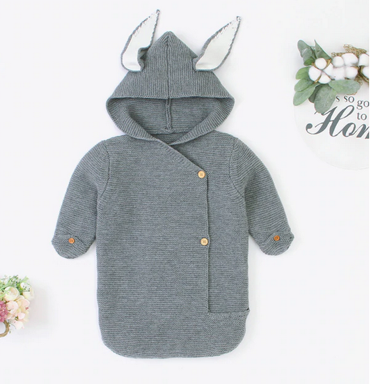 Annie & Charles grey knitted sleeping bag with button hand closures and gentle hood detail