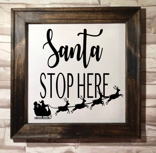 Santa Stop Here framed canvas in dark walnut by Works of Panglossian, ready to hang with optional sawtooth hanger included.