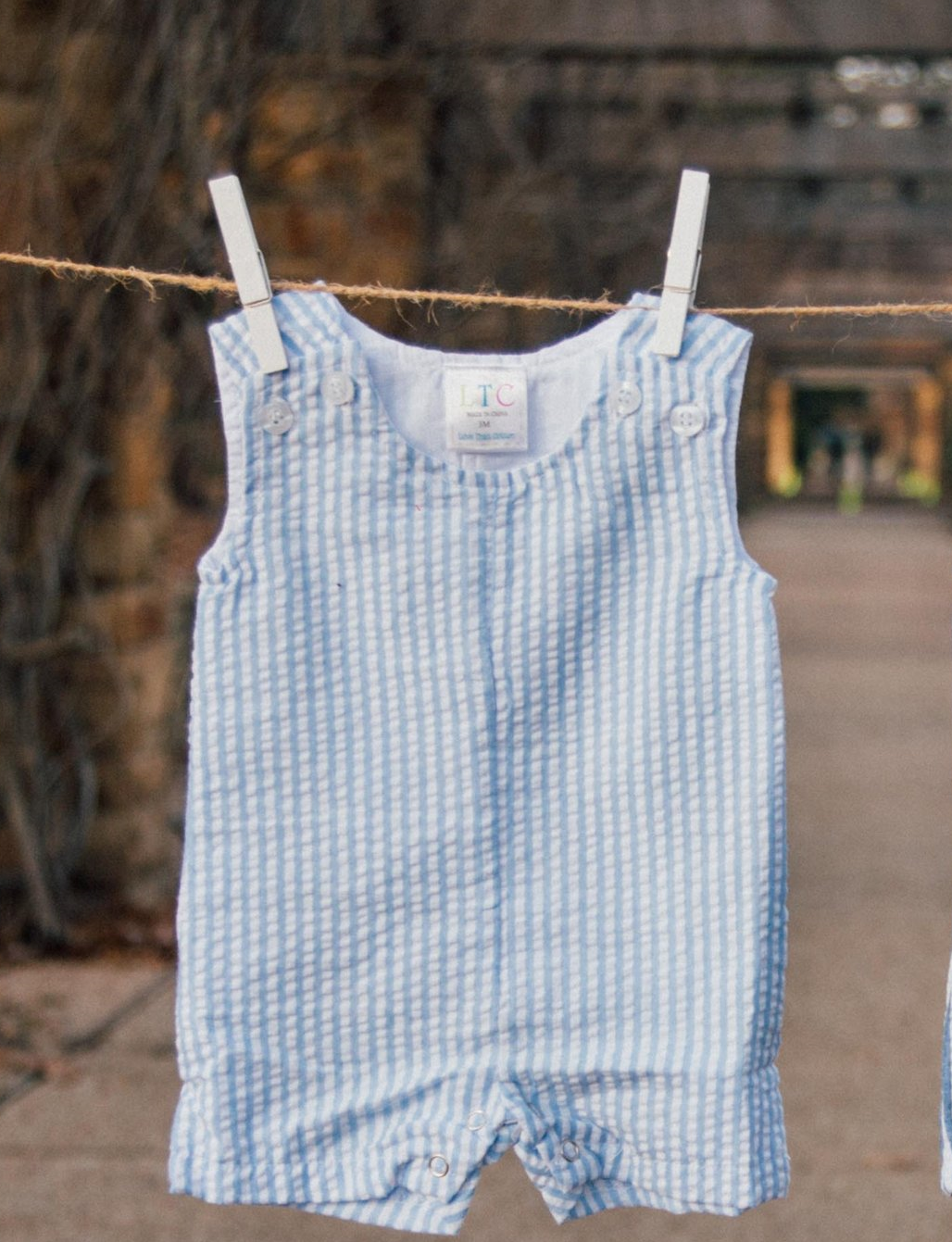Blue seersucker jon jon with double shoulder buttons and snap crotch closure by Love That Cotton