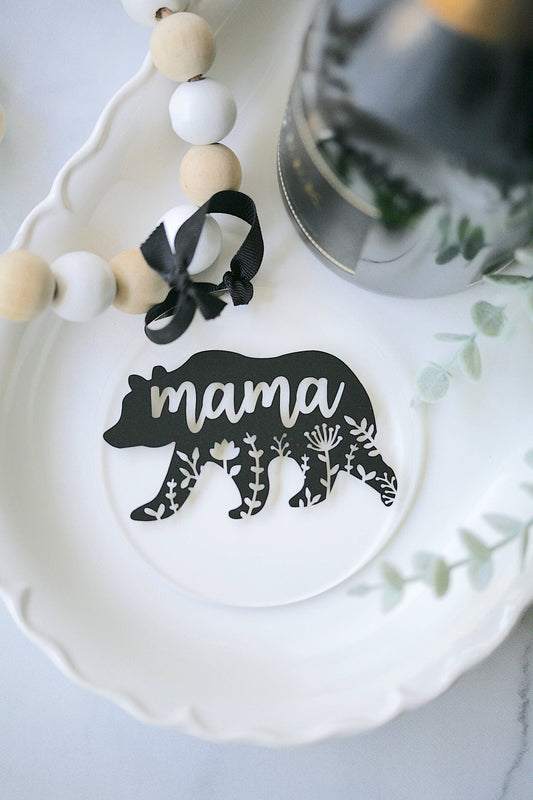 Clear acrylic ornament with detailed mama bear mandala design, suspended by black ribbon