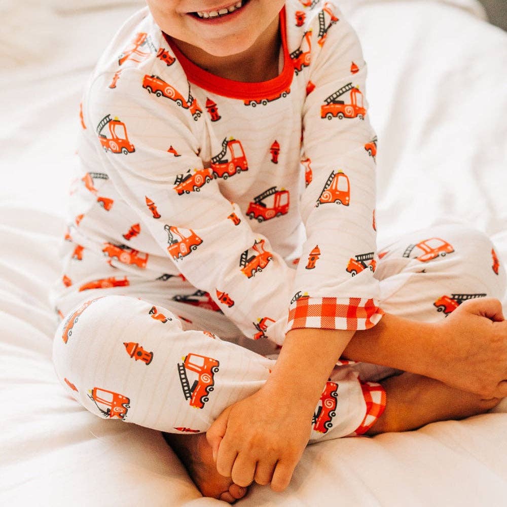 Red firetruck print pajamas with plaid trim and buttflap by Sugar Bee Clothing