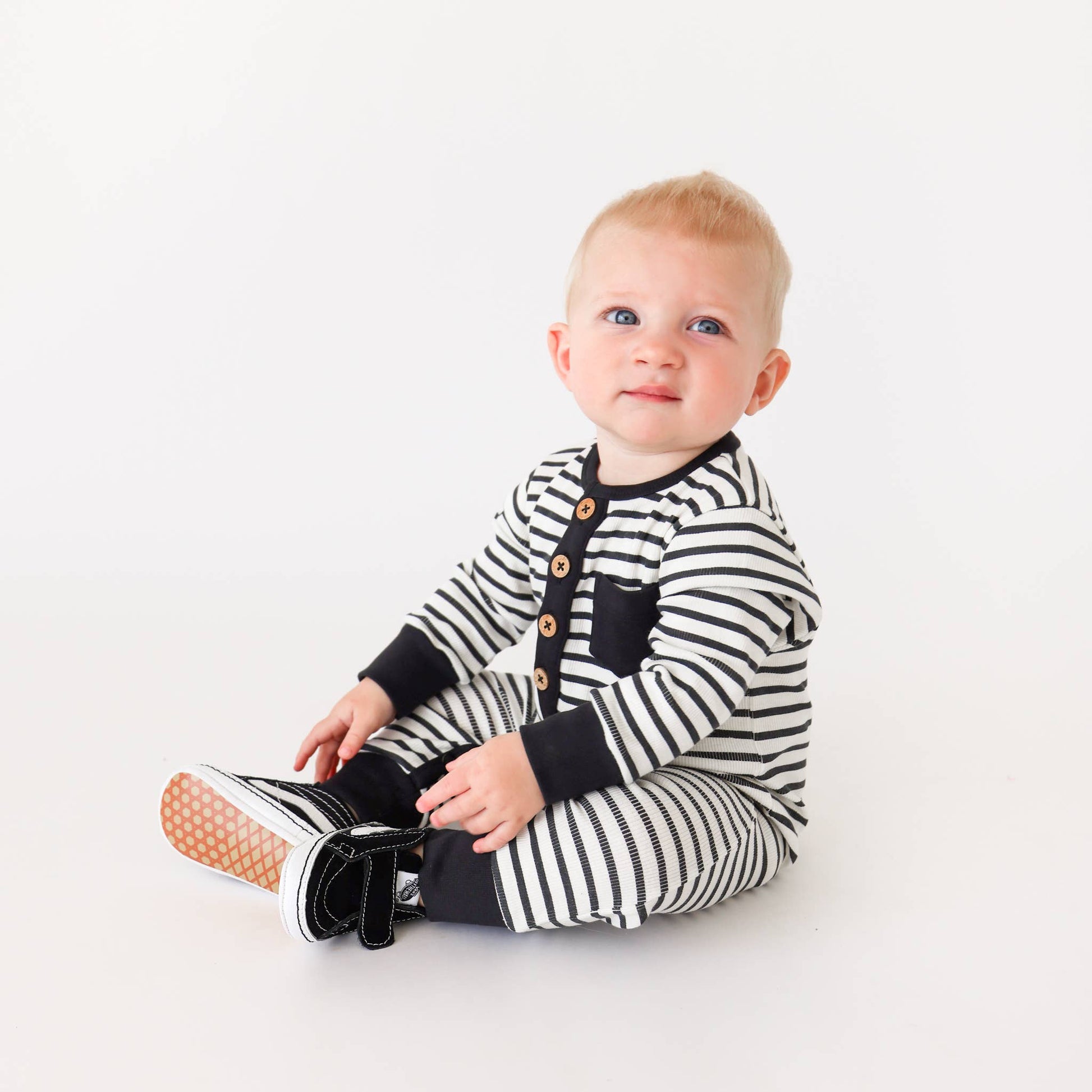 Jet Black Stripe long sleeve romper with wooden button placket and contrast trim