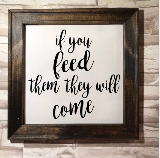 Framed canvas artwork reading "If you feed them they will come" in Dark Walnut finish