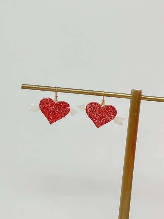 Acrylic glitter bow and arrow heart dangle earrings with delicate sparkle accents