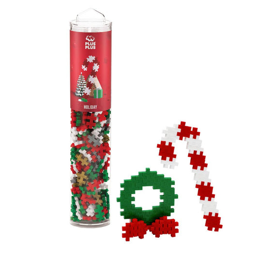 Plus-Plus Tube 240-piece holiday mix with vibrant, gold, and silver building pieces in reusable container