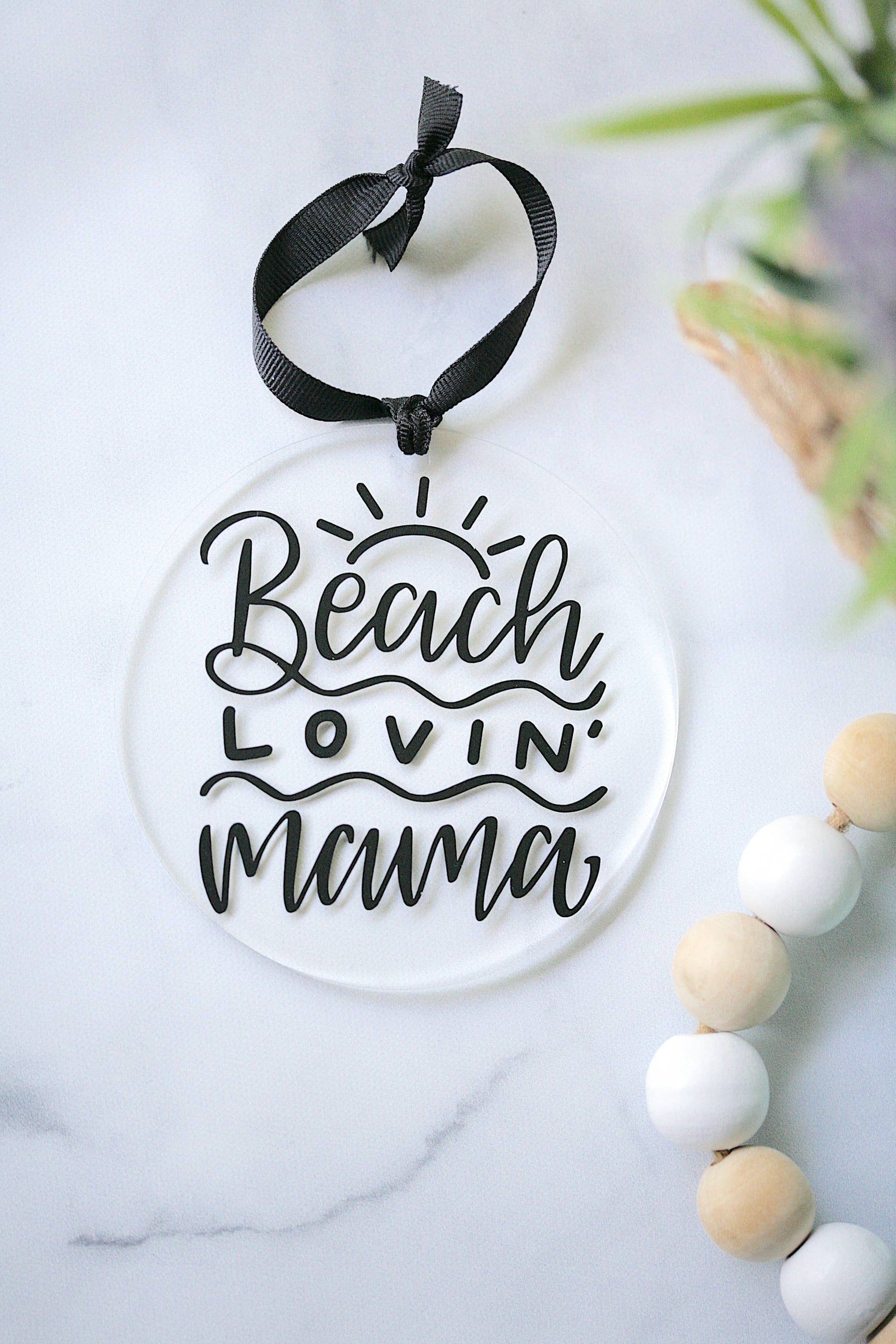 Beach Lovin Mama clear acrylic ornament by Younique, 4 inches, hanging from black ribbon